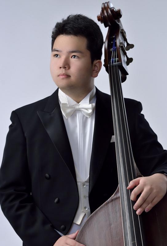 コントラバスをかかえ白い蝶ネクタイに黒の背広をきた男性。桑原孝太朗写真。