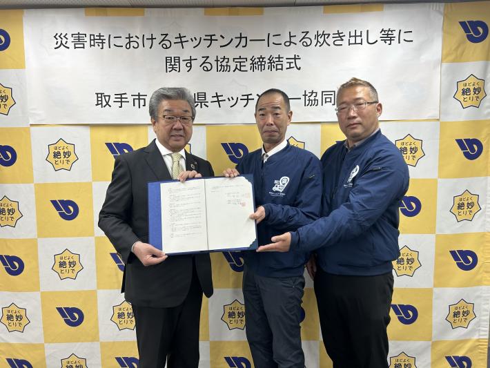 協定締結に際し集合写真を撮る市長