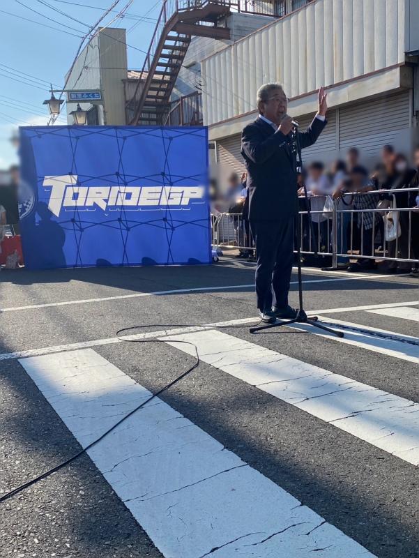 道路上でマイクを持つ男性