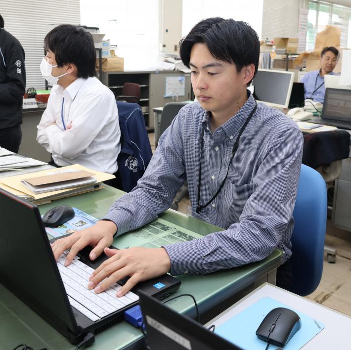 男性がパソコンをタイピングをしている