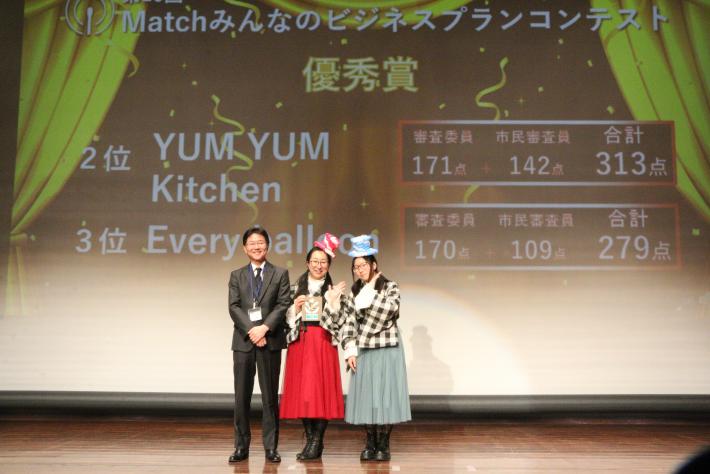 優秀賞受賞のかたが記念写真を撮っている様子