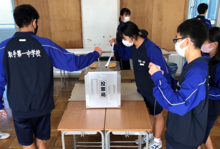 取手第一中学校の生徒会選挙にて、候補者名を記載した投票用紙を投票箱に入れる様子